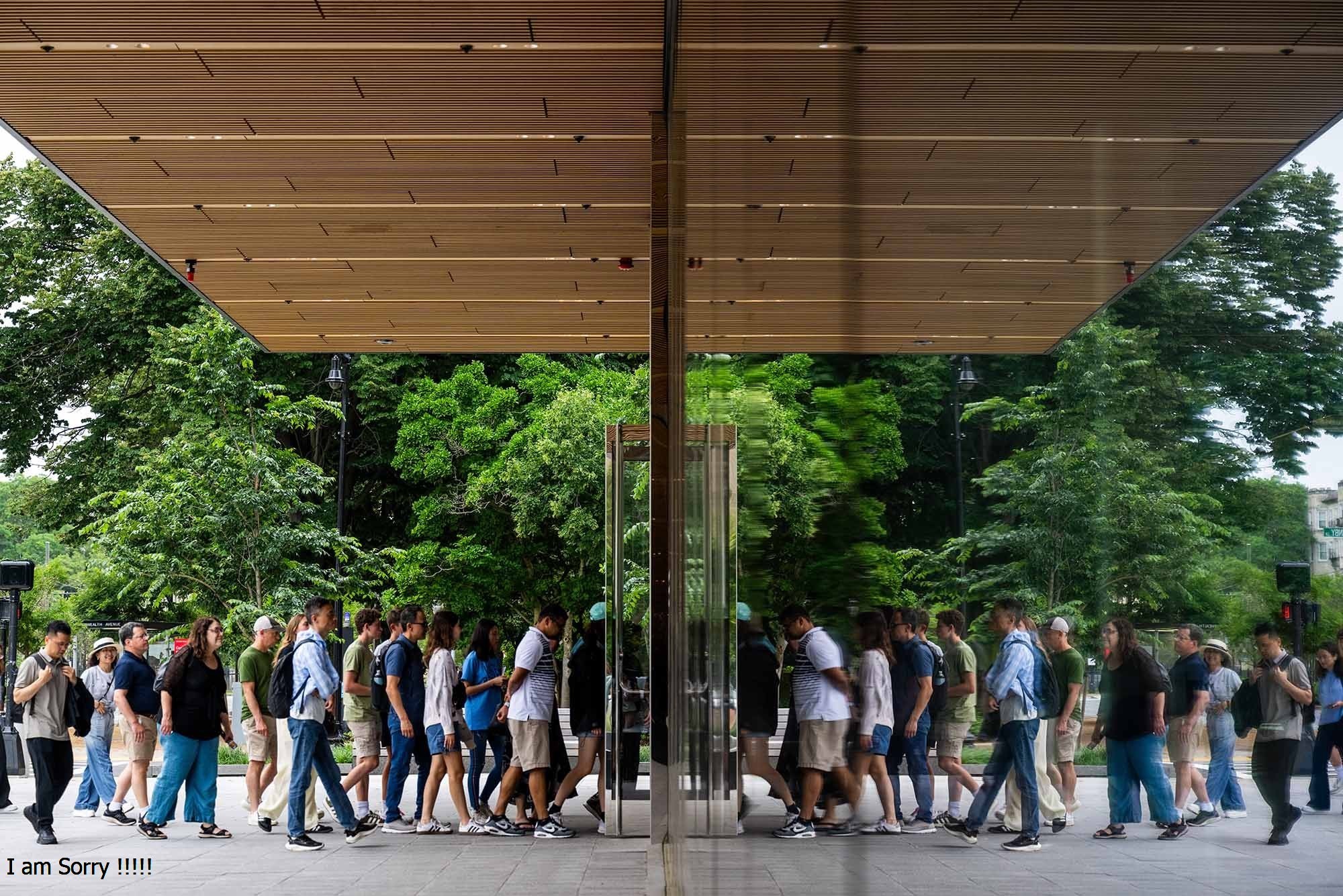 Students walking into a building that mirrors their image